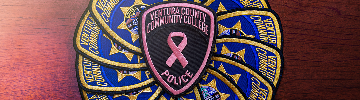 Photo of VCCCD PD Pink Patch on top of a file of regular VCCCD PD patches.