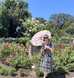Rachel Johnson in a garden with a parasol